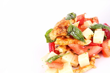 Chicken, cheese & vegetable salad with some bread on a plat