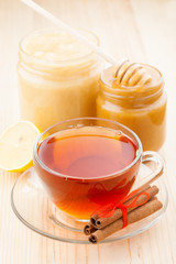 honey in jar and cup of healthy tea