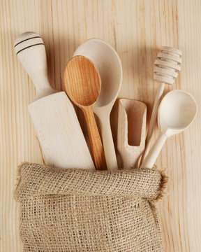 wooden kitchen utensils:spoons, rolling pin, scoop and honey dip