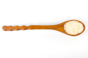 uncooked Rice on a wooden spoon.