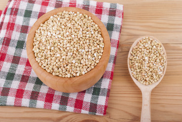 Buckwheat in a bowl on a wooden table.