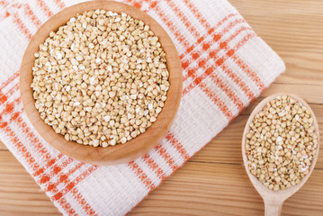 Buckwheat in a bowl on a wooden table.