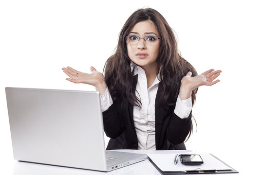 Confused And Beautiful Young Business Woman At The Desk