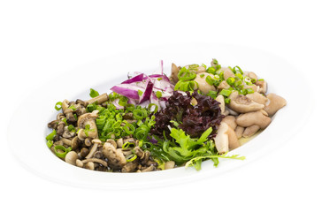 plate of marinated mushrooms on a white background