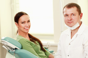 Fototapeta premium Young woman with dentist in a dental surgery.