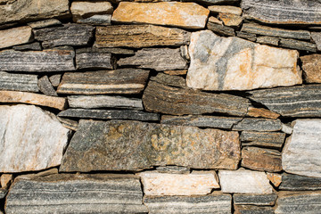 Wall built of stones. Sun light