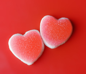 Fototapeta premium Sugar hearts on red background