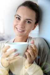 Beautiful woman at home drinking hot tea