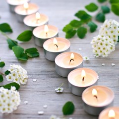 Burning candles and hawthorn blossom