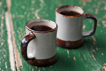 Two cups of coffee on old wooden table