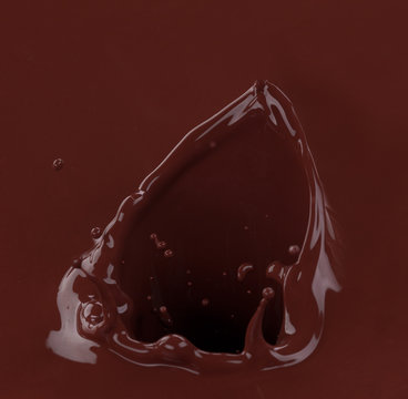 Splash of brownish chocolate isolated on white background