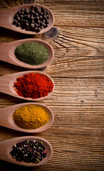 Assorted spices on wooden background