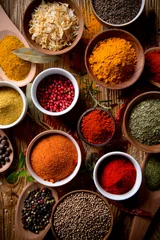 Fotobehang Assorted spices on wooden background © Lukas Gojda