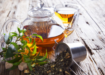 Transparent cup of green tea on wooden background