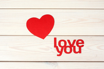 Red  heart symbol on a wood background