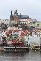 Obraz premium Snowy gotycki zamek praski nad rzeką Wełtawą, Republika Czeska
