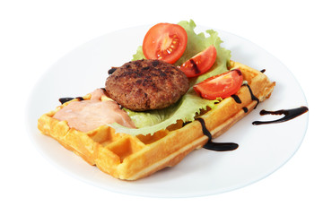 Belgian waffle with beefsteak, tomato slices, lettuce leaf and s
