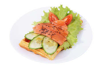 Belgian waffle with sliced salted salmon, tomatoes, cucumbers, l