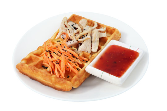 Belgian waffle with chicken and carrot salad.