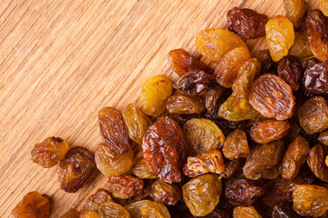 Diet healthy food. Border of raisin on wooden background