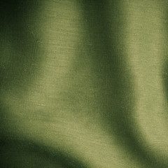 green background abstract cloth wavy folds of textile texture