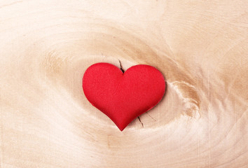 red heart on a light wooden background