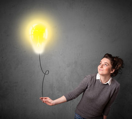 Woman holding a lightbulb balloon