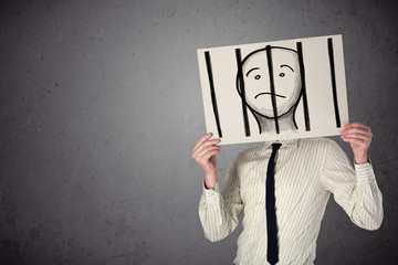 Businessman holding a paper with a prisoner behind the bars on i