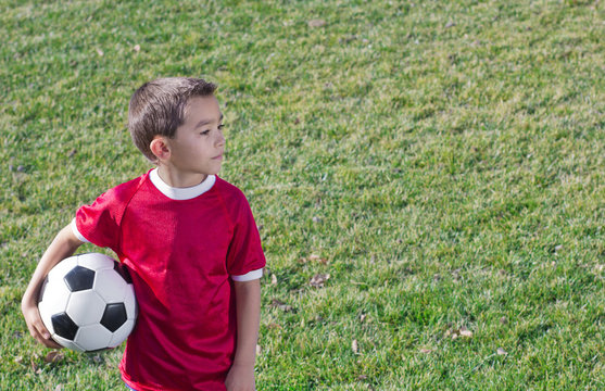 Young Hispanic Soccer Player on Grass field