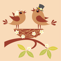 Birds bride and groom are singing about their love in a nest.
