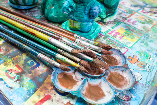 oil paints and paint brushes on a palette