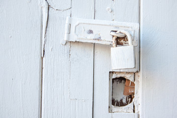 Old padlock on a wooden door