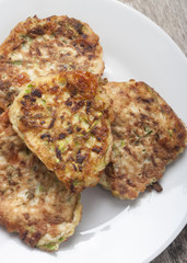 zucchini pancakes on white plate top view