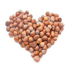 hazelnuts in shape of heart isolated on white