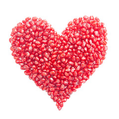 Fototapeta na wymiar heart-shaped pomegranate seeds isolated on white