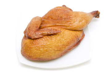 roasted chicken on a plate on white background