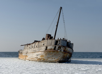 Old ruined-ship tossed on the sea shelf