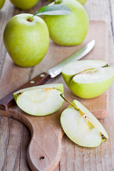 fresh green sliced apples and knife