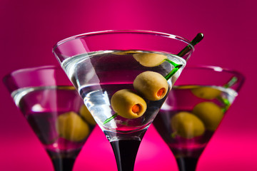 glasses with martini and green olives