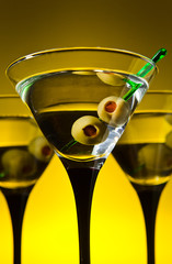 glasses with martini and green olives