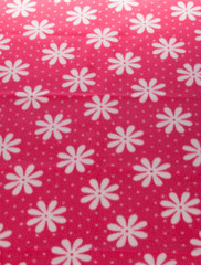 white  flower on red  fabric background texture