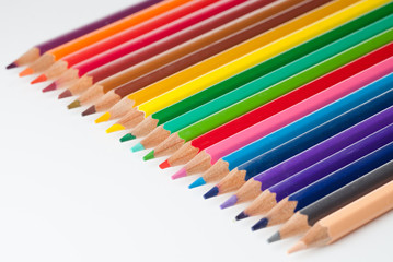 Row of colorful pencils on white background