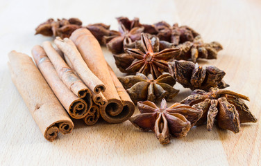 Macro shot of a star anise and cinnamon sticks on a wooden backg