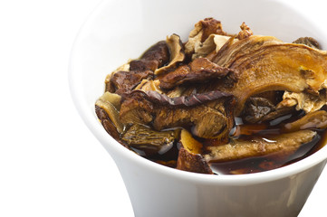 cinnamon sticks and dried porcini mushrooms in jar