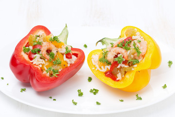 stuffed peppers with salad of rice and shrimp on the white plate
