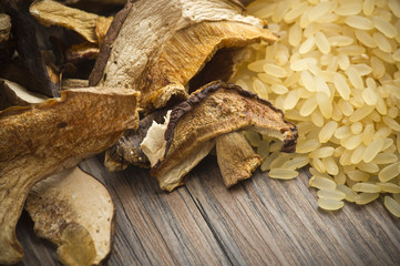 Rice and dried porcini mushrooms on table