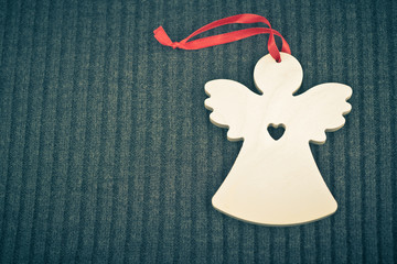 Craft Wooden Angel on Grey Knitted Background