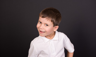 boy portrait in white shirt on black