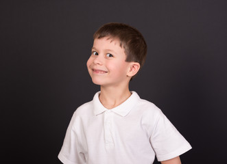 boy portrait in white shirt on black