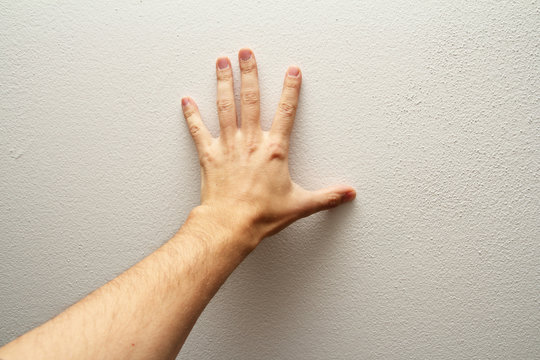 Hand Pushing Wall